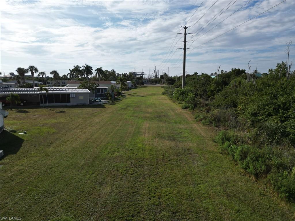 Image 3: Looking South across the large grassy area to the rear of the lot