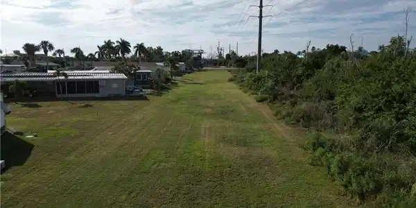 Image 3: Looking South across the large grassy area to the rear of the lot