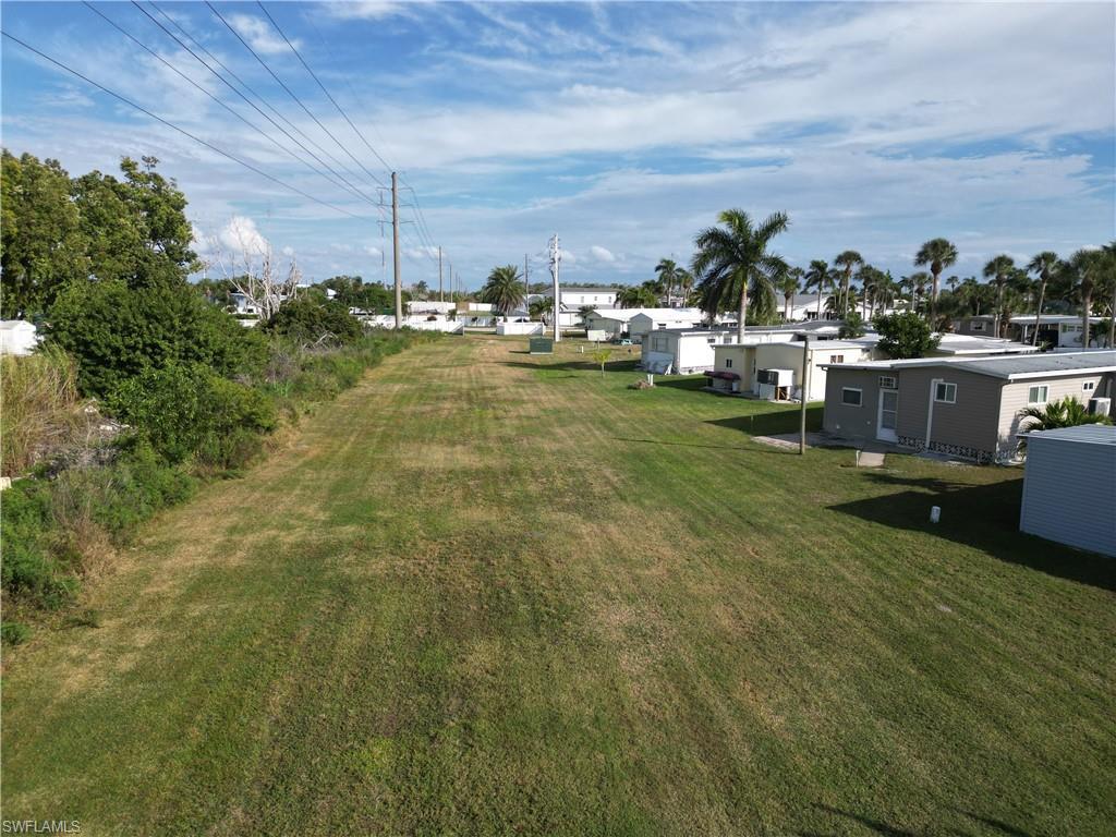 Image 4: Looking North across the large grassy area to the rear of the lot