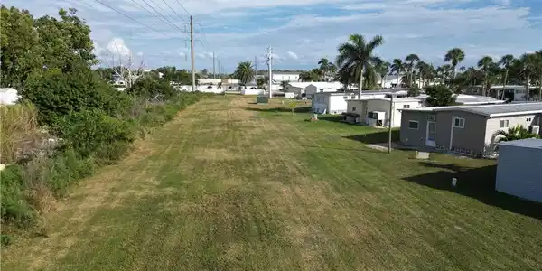 Image 4: Looking North across the large grassy area to the rear of the lot