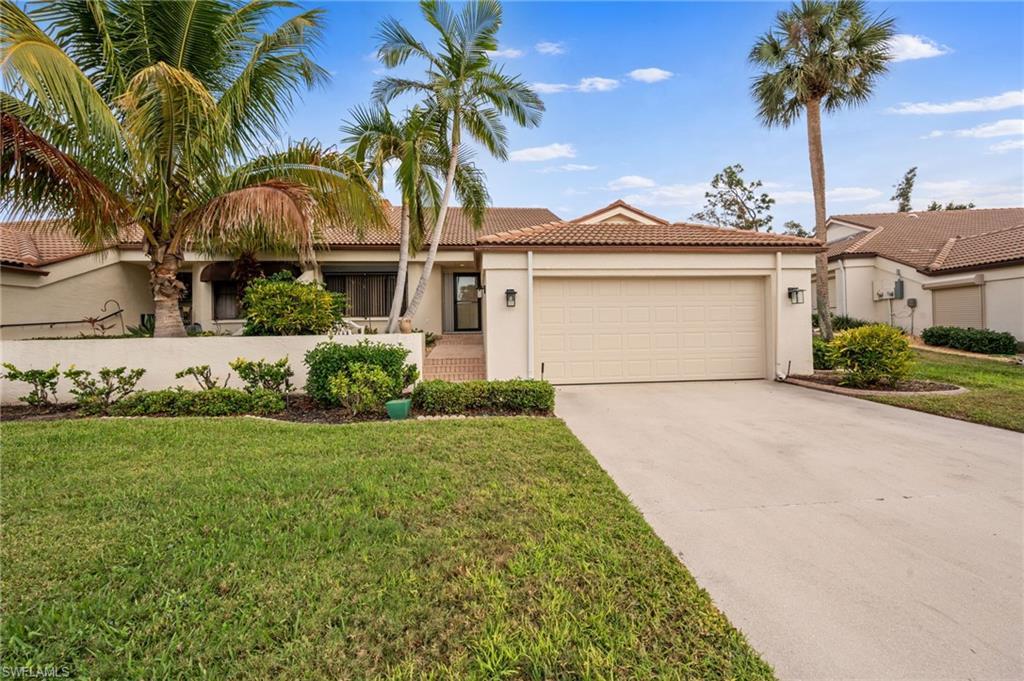 Image 1: View of front of property featuring a tile roof, stucco siding, driveway, a garage, and a front yard