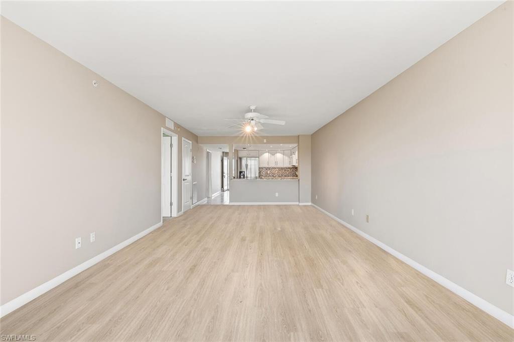 Image 3: Unfurnished living room featuring light wood-style floors and a ceiling fan