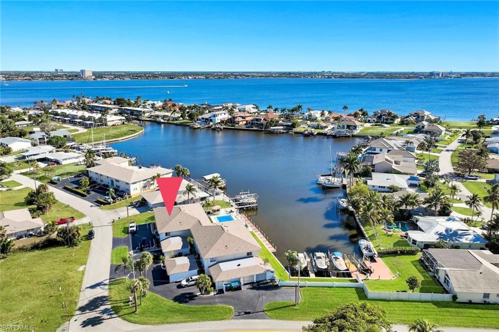 Image 1: Aerial view of residential area with a large body of water