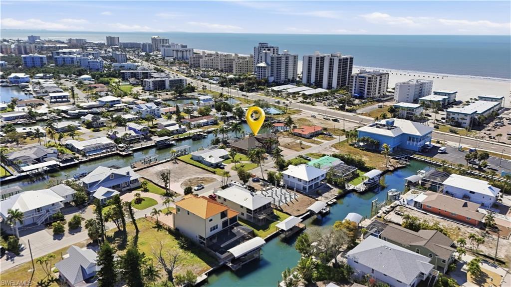 Image 4: View of property location with a large body of water and nearby urban area - Virtually Edited Image