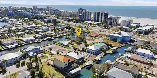 Image 4: View of property location with a large body of water and nearby urban area - Virtually Edited Image