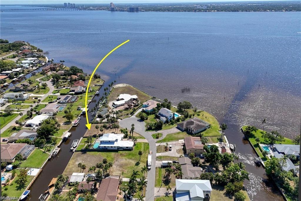Image 4: Aerial perspective of suburban area with a nearby body of water