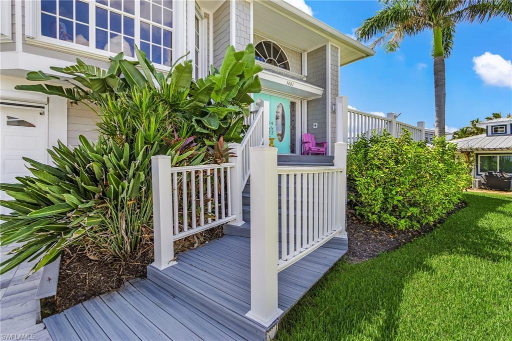 Image 2: View of home's exterior featuring a garage and a yard
