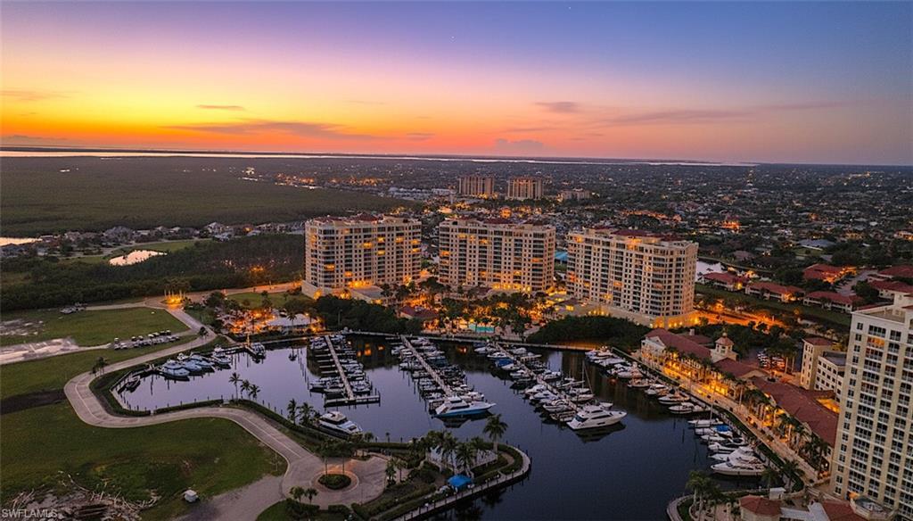 Image 1: Aerial view of property and surrounding area with a nearby body of water and numerous boat docks