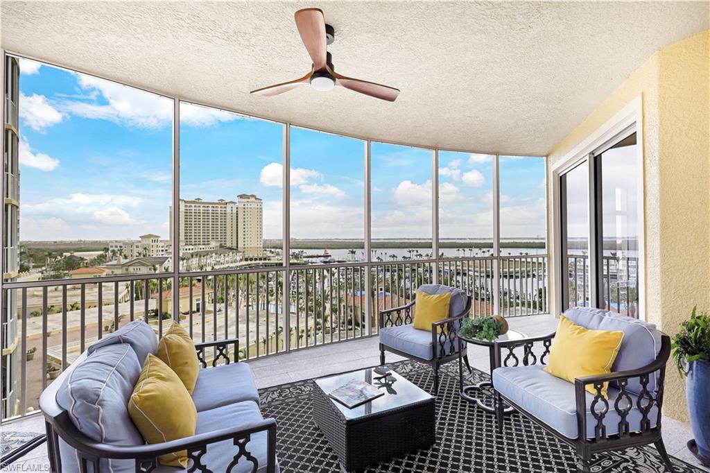 Image 3: Sunroom with expansive windows, a textured ceiling, and a city view