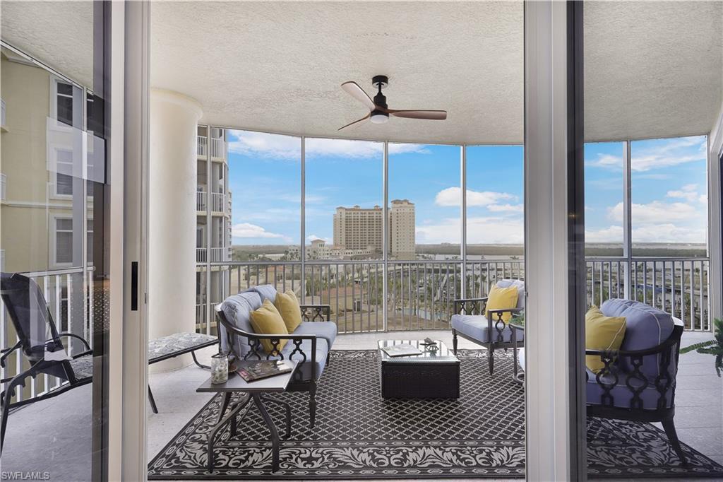 Image 4: Sunroom / solarium with expansive windows, a city view, and a textured ceiling