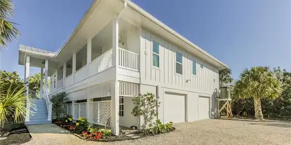 Image 2: View of home's exterior featuring a garage and a balcony