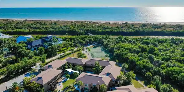 Image 3: Aerial view of residential area with a pool area