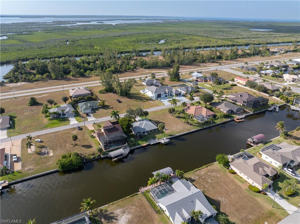Image 4: Aerial overview of property's location with a nearby body of water and nearby suburban area