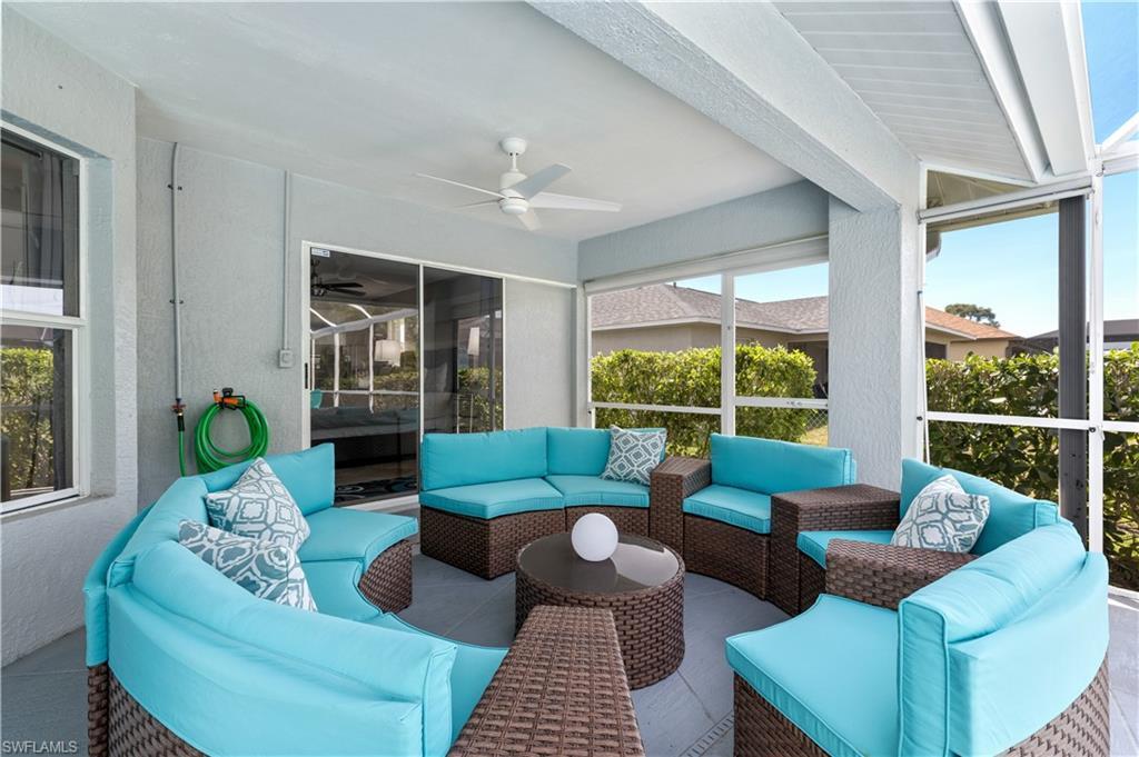 Image 3: Covered seating area on lanai by pool.