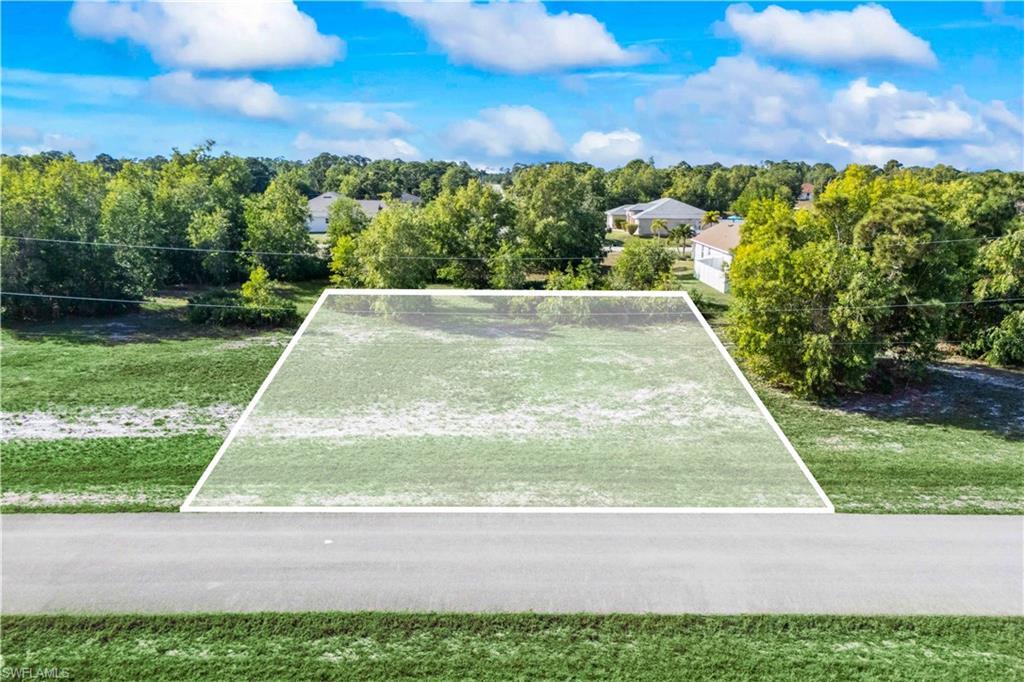 Image 2: Street view of a peaceful lot in the heart of NW Cape Coral.