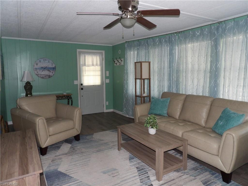 Image 3: Living area featuring wood finished floors, ceiling fan, and crown molding