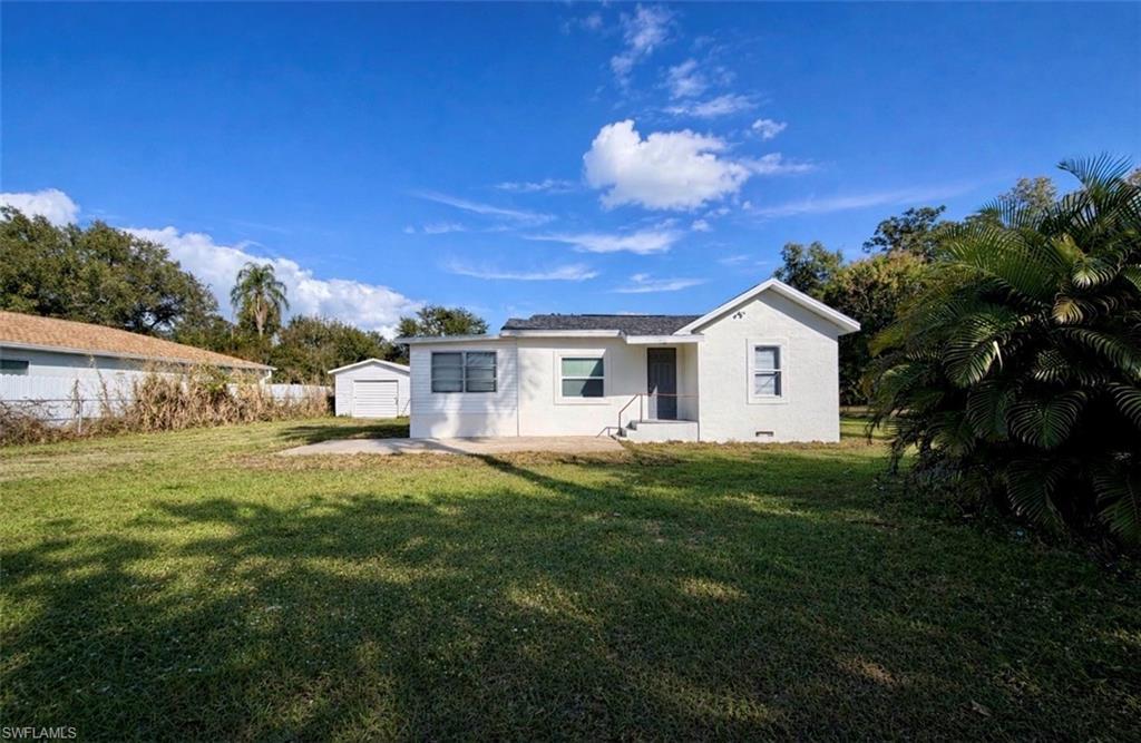 Image 2: Back of property with an outbuilding