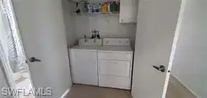 Image 4: Washroom with washer and clothes dryer and baseboards