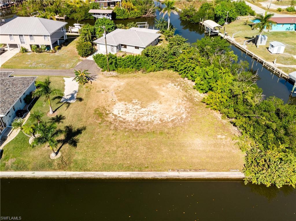 Image 1: Aerial view of residential area with a nearby body of water