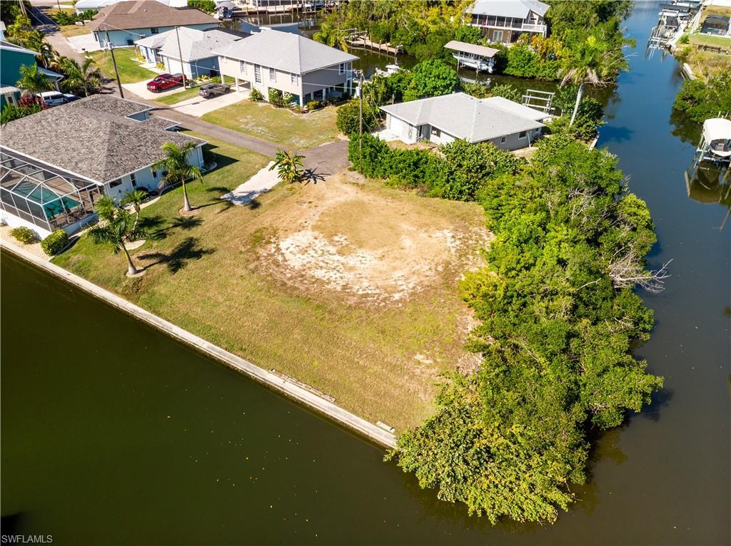 Image 2: Aerial view of residential area featuring a nearby body of water