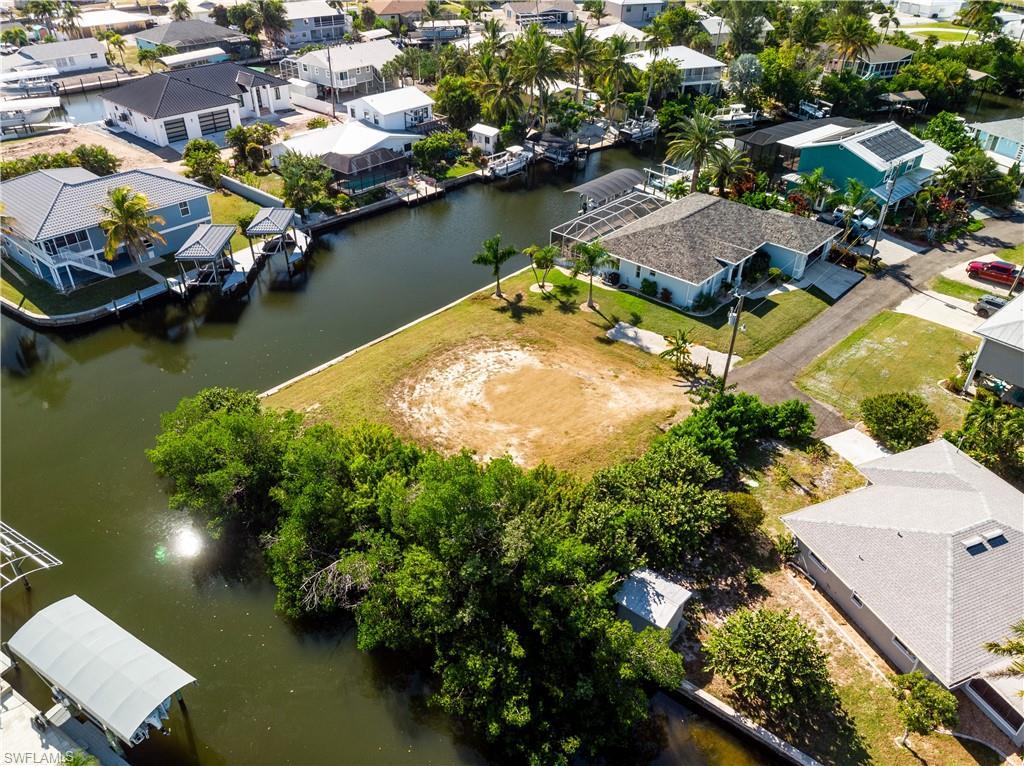 Image 3: Aerial view of residential area with a nearby body of water