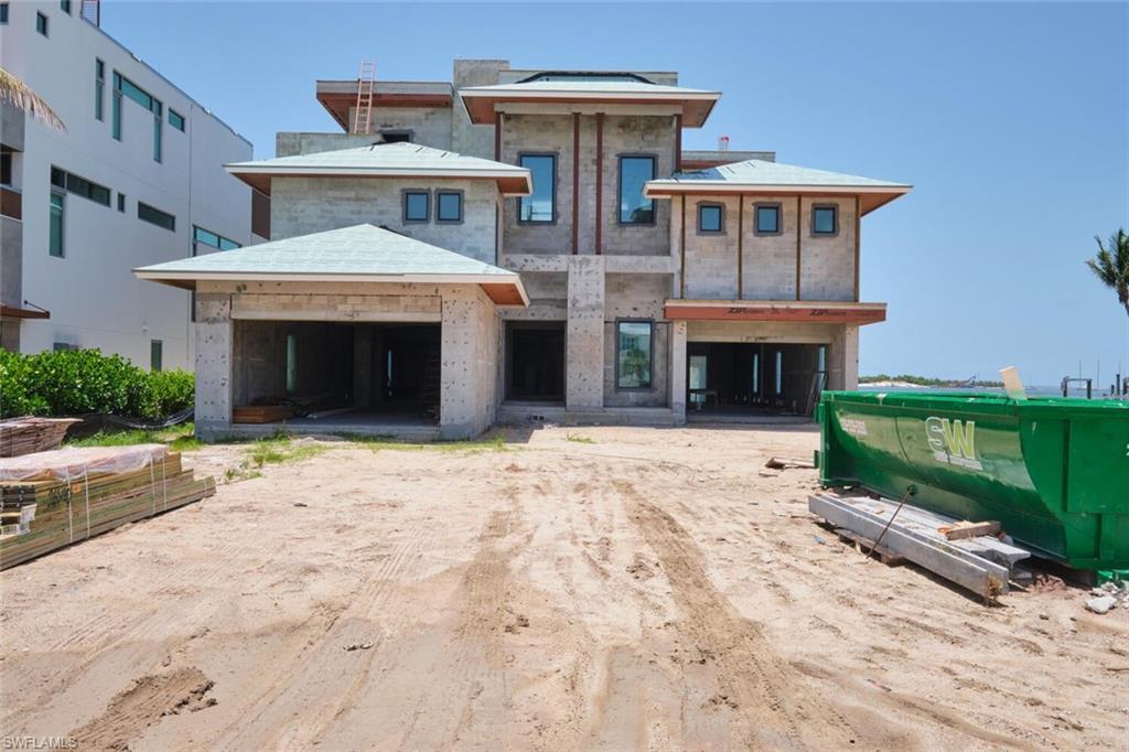 Image 2: View of front facade featuring a garage