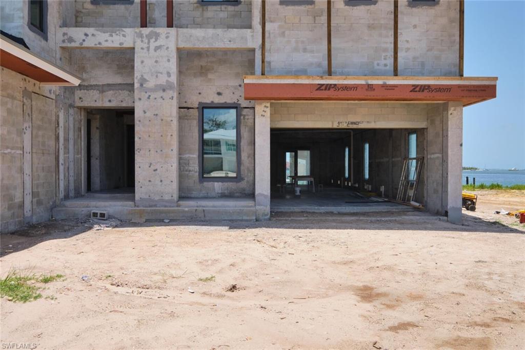 Image 4: Doorway to property featuring a water view and stone siding