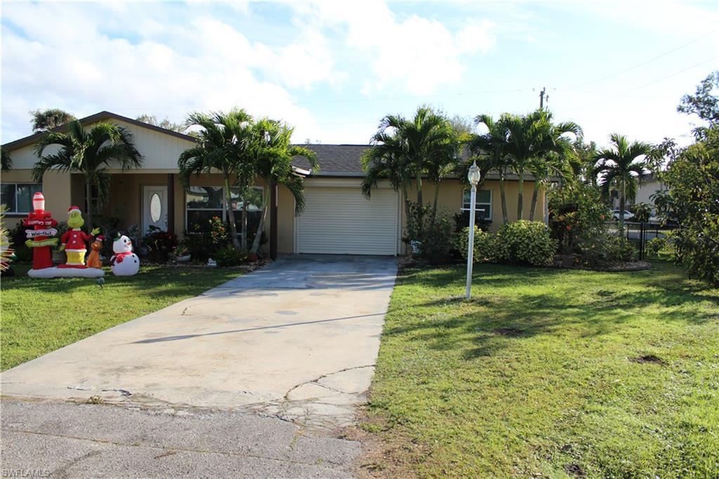 Image 1: Ranch-style house featuring driveway, a front yard, and an attached garage