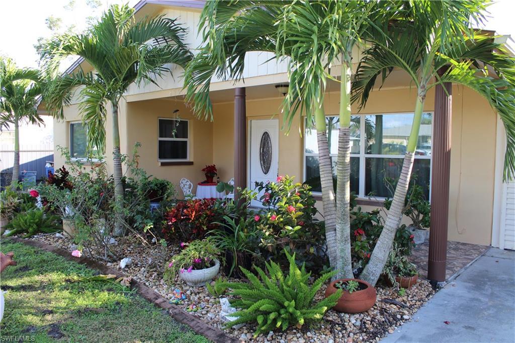 Image 2: Property entrance with stucco siding and covered porch