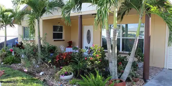 Image 2: Property entrance with stucco siding and covered porch