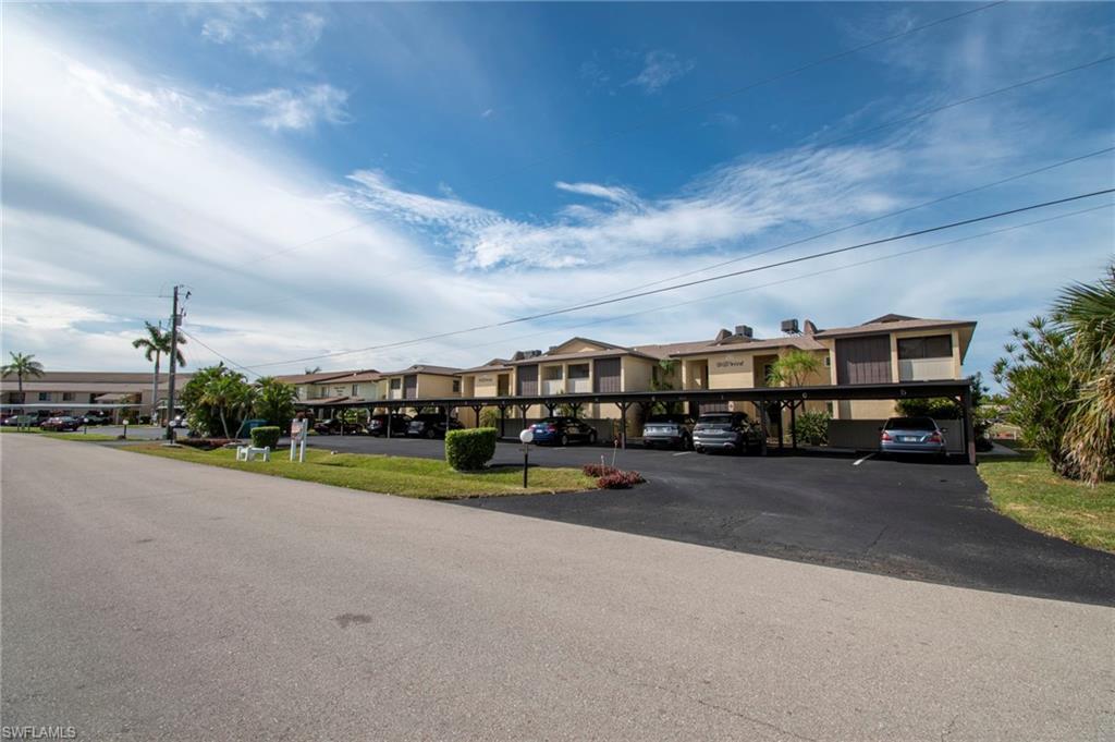 Image 2: View of asphalt road featuring a residential view