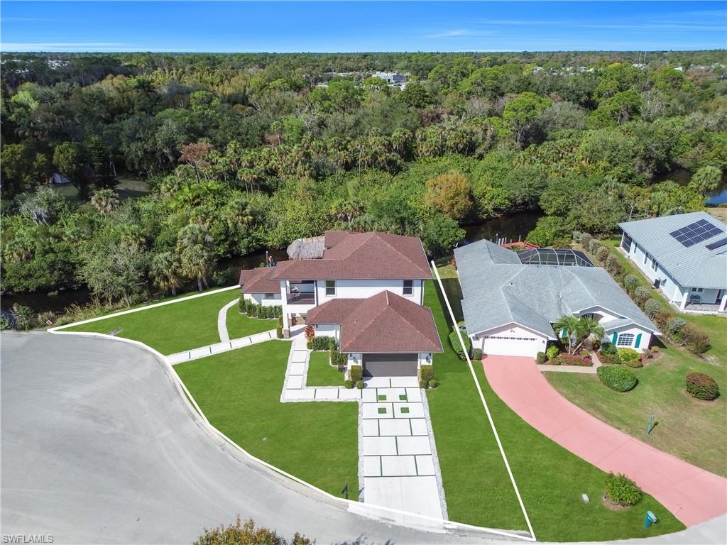 Image 4: Aerial view of residential area featuring a forest
