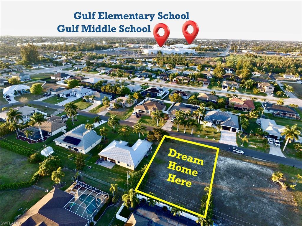 Image 1: Aerial view of residential area featuring property parcel outlined