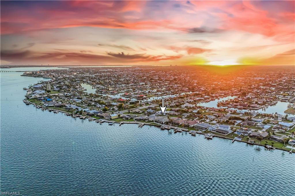 Image 2: Aerial view at dusk featuring a water view