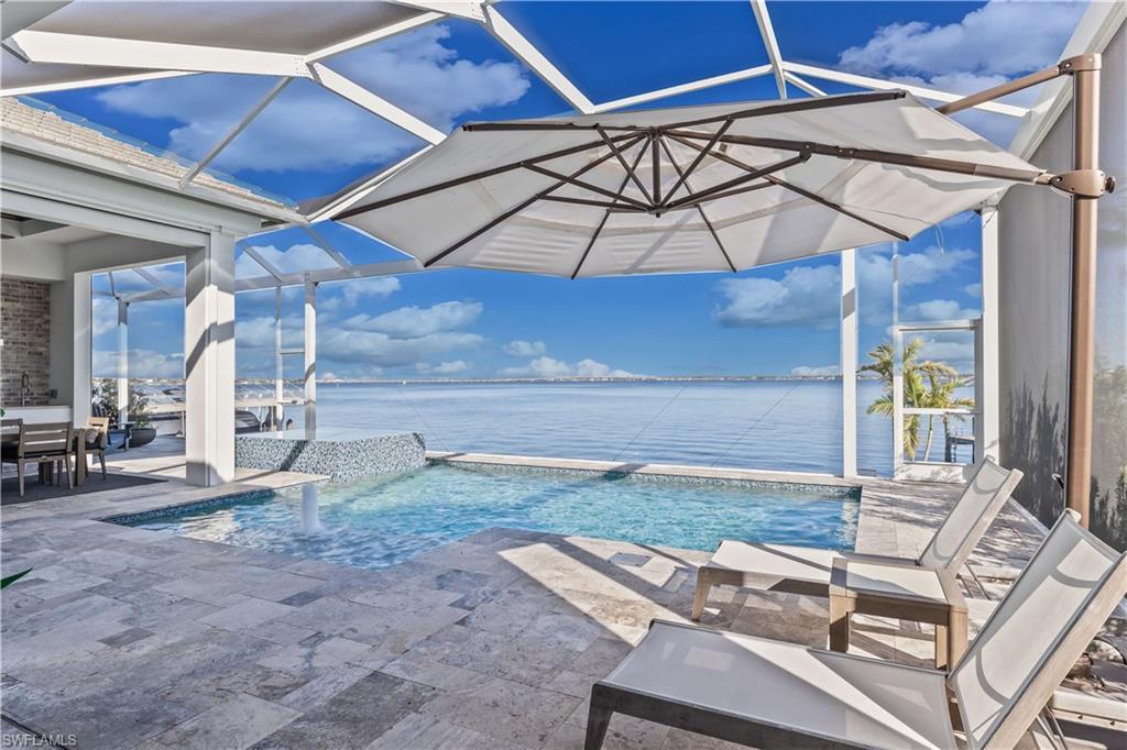 Image 3: View of swimming pool featuring a water view and a patio