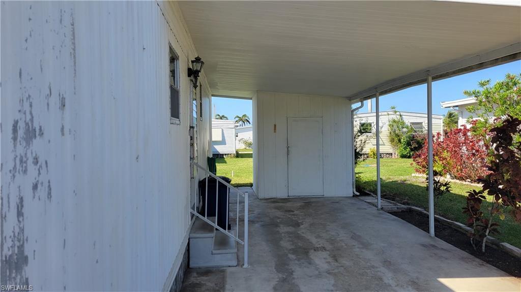 Image 2: View of patio featuring a carport