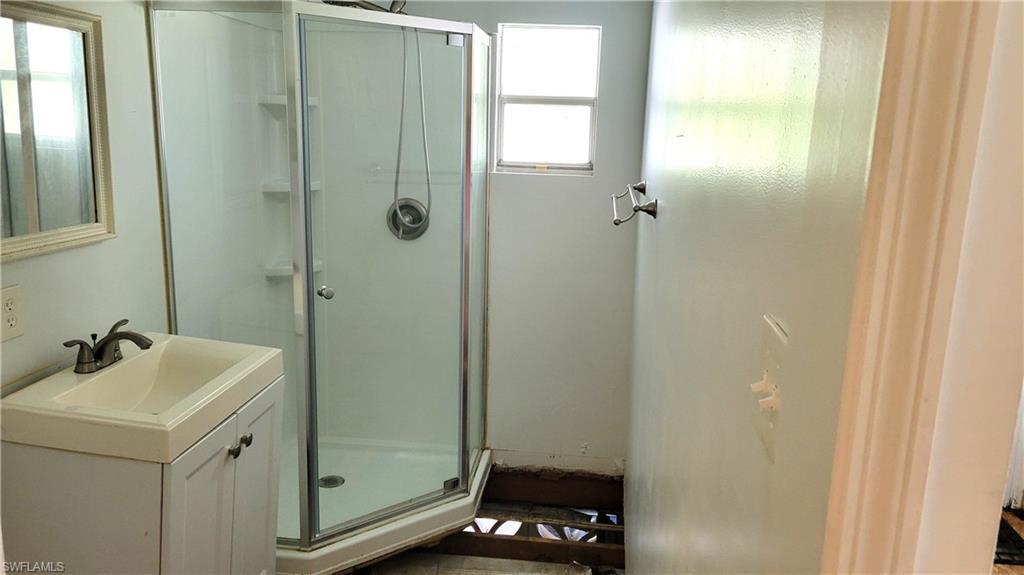 Image 4: Bathroom featuring a stall shower and vanity