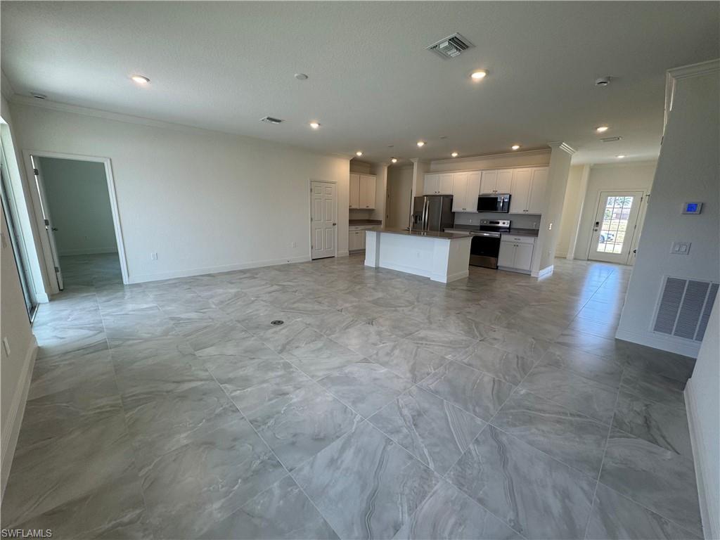 Image 3: Unfurnished living room featuring baseboards, recessed lighting, and crown molding