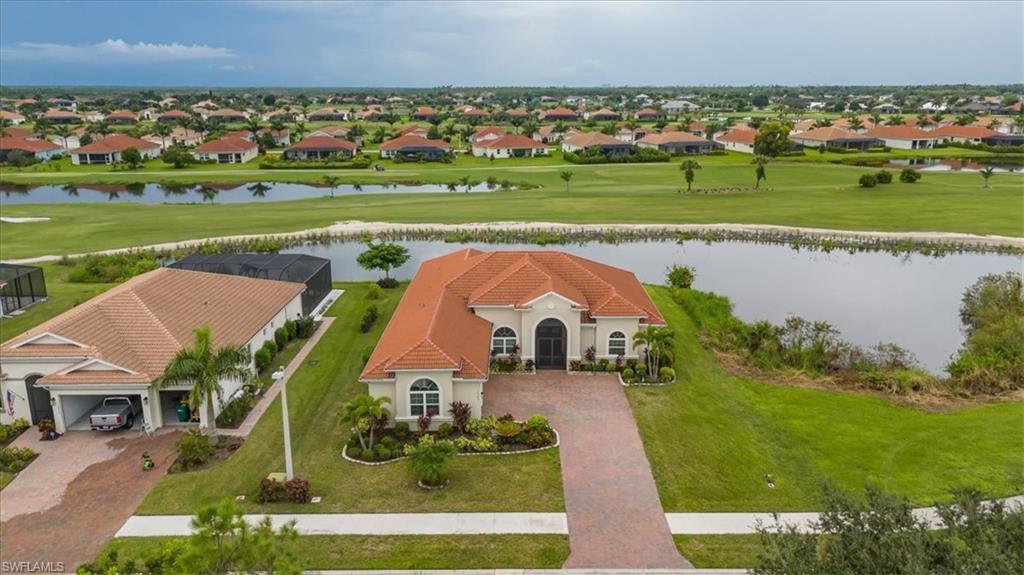 Image 3: Aerial perspective of suburban area featuring a large body of water and a golf course