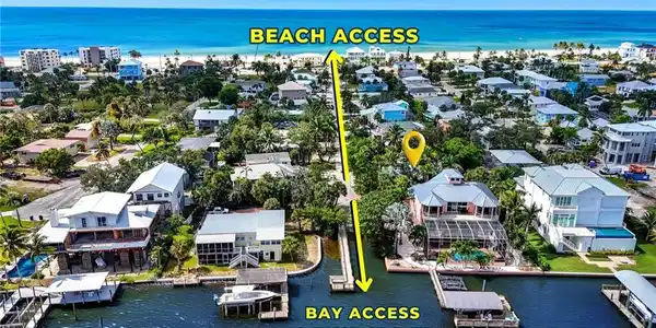 Image 3: Aerial view of residential area with a nearby body of water - Virtually Edited Image