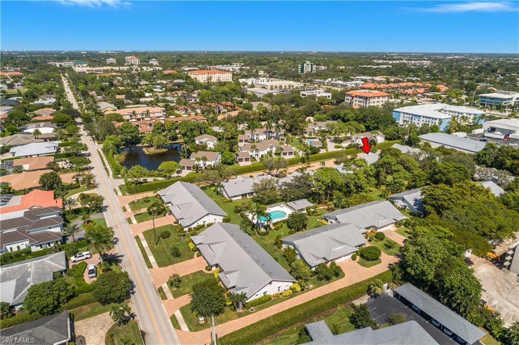 Image 3: Aerial view of property and surrounding area featuring a nearby body of water and nearby suburban area