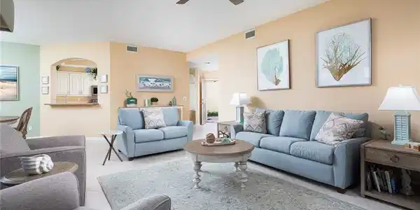 Image 3: Tiled living area with visible vents, arched walkways, and ceiling fan