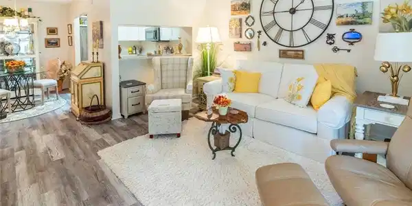 Image 2: Living room featuring vinly wood-like flooring and a chandelier