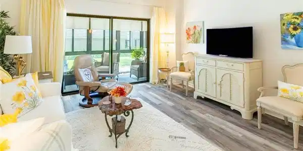 Image 3: Living room with vinyl wood-like flooring and crown molding