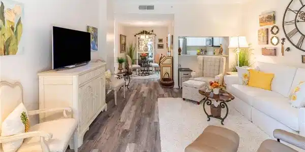 Image 4: Living area featuring vinyl wood-like flooring and ornamental molding