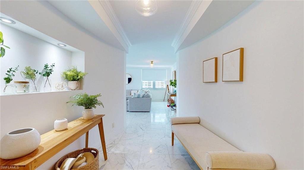 Image 1: Corridor featuring ornamental molding and light marble finish flooring