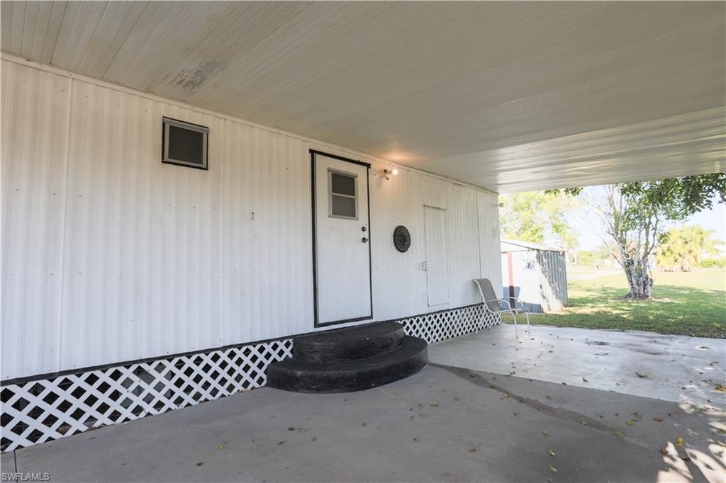 Image 4: Property entrance featuring a patio and a lawn