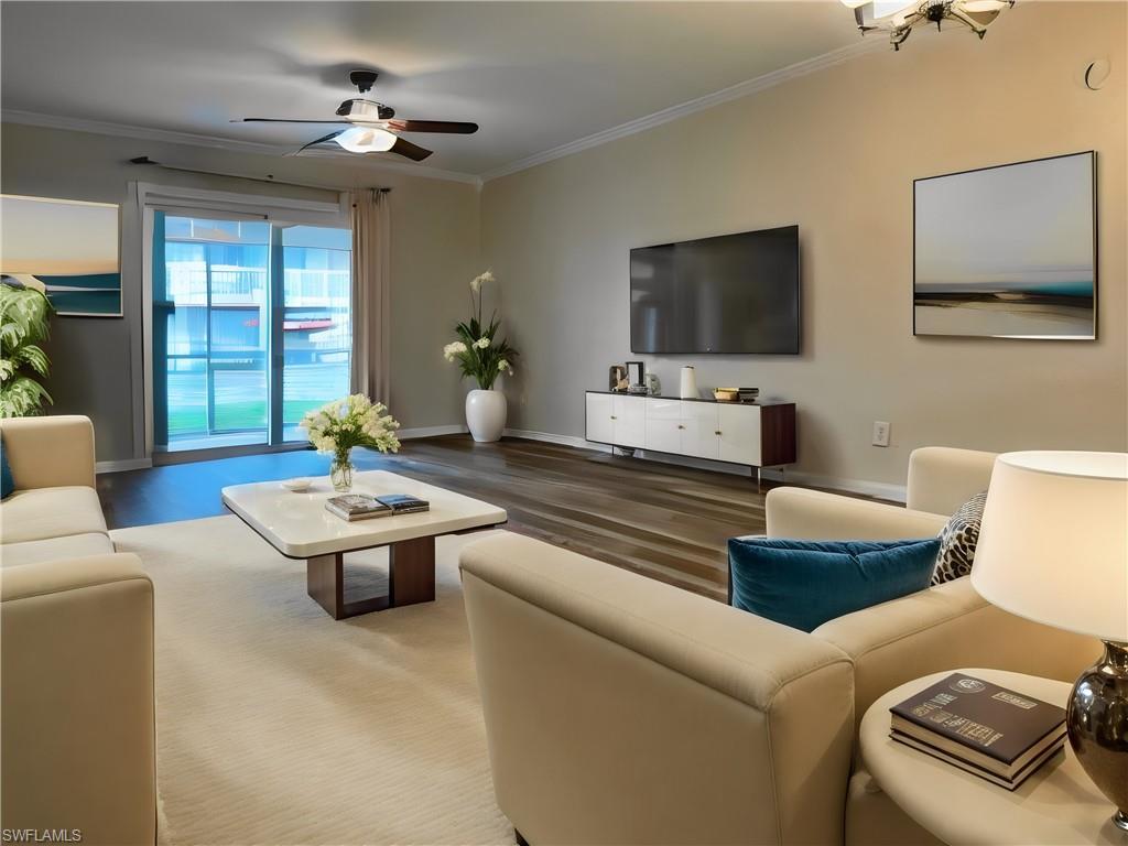 Image 3: Living area featuring crown molding, ceiling fan, and vinyl finished floors