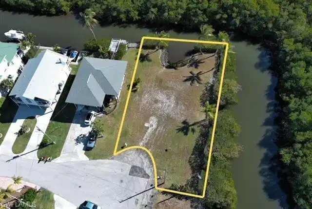 Image 1: Aerial view of property's location featuring a nearby body of water and property parcel outlined