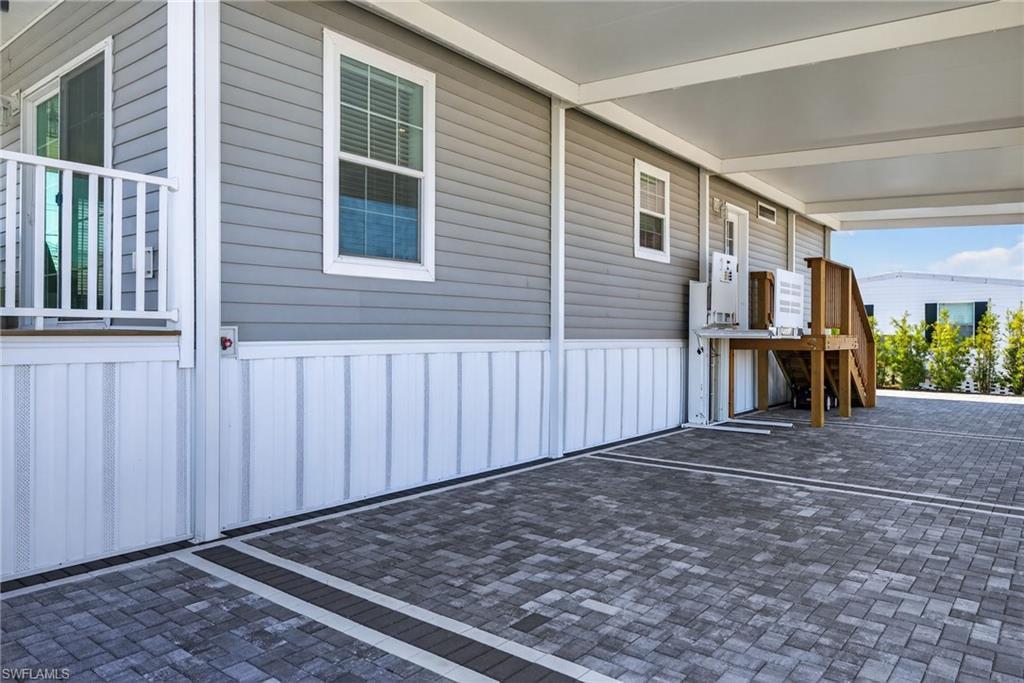 Image 4: Wheelchair lift, paver driveway, carport and stairs